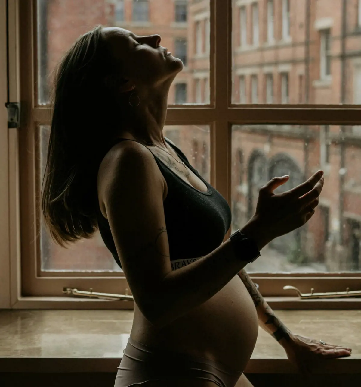 Pregnant woman by a window representing how sperm can survive up to five days inside the female reproductive system