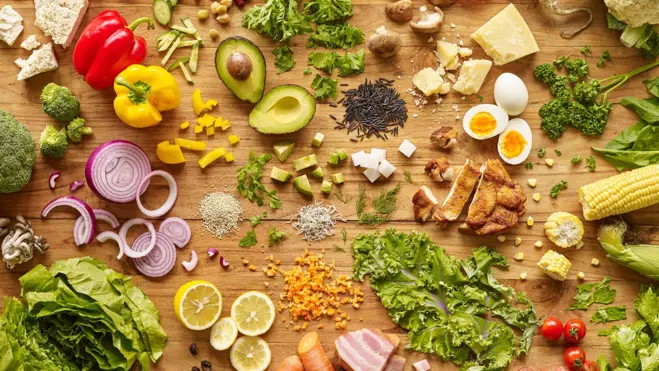 Fresh vegetables and fruits displayed on a wooden table, representing nutritious choices for conception advice.