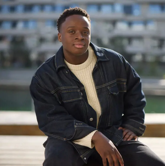 A man on a bench, considering his decision to be a sperm donor.